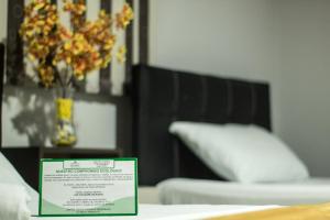 Postel nebo postele na pokoji v ubytování Hotel Escorial Ibagué