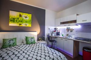 Il comprend une cuisine et une chambre avec un lit et un comptoir. dans l'établissement Studio Apartment Petrzalka Air-Conditioned 24h check-in, à Bratislava
