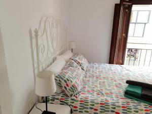 A bed or beds in a room at HISPALIS SAN LUIS
