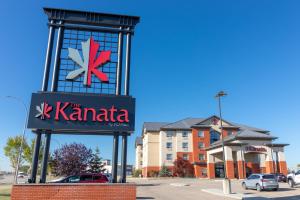um sinal para o sinal de kaminaria em frente a um edifício em The Kanata Fort Saskatchewan em Fort Saskatchewan
