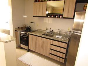 a kitchen with a sink and a stove at Apartamento Palmas in Palmas