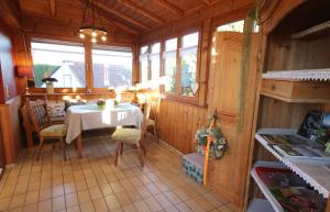a dining room with a table and some windows at Ferienhaus an der Iller in Aitrach
