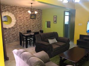 a living room with a couch and a table at Darrel House in Kisumu