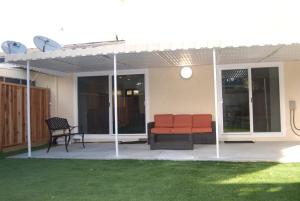 a patio with awning and a couch and chairs at Silicon Valley Stays Casa Tres in Mountain View