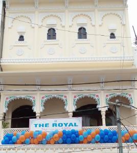 a building with a sign and balloons in front of it at The Royal Jag Villa in Udaipur