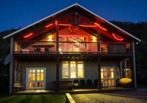 a house with lights on the side of it at The Ghost Lodge in Granity