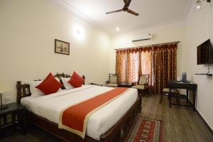 a bedroom with a bed and a desk in a room at Moti Mahal - A Heritage Haveli in Pushkar +48 photos