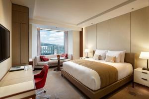 a hotel room with a bed and a large window at Lotte Hotel Seoul Executive Tower in Seoul