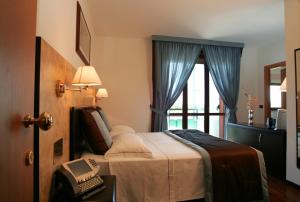 Cama o camas de una habitación en Residence Le Magnolie