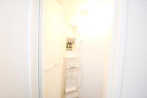 a refrigerator with a door open in a room at Guest House Re-worth Yabacho1 402 in Nagoya +15 photos