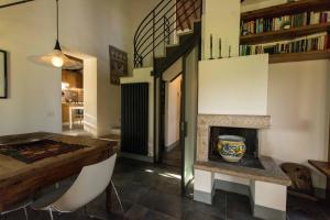 a living room with a table and a fireplace at Monteriggioni Suite in Monteriggioni