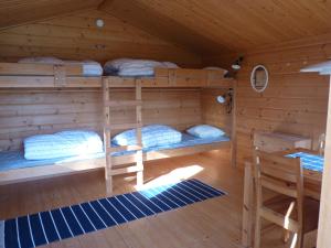 a bedroom with bunk beds in a log cabin at 4 persoons Stuga in Hammarstrand