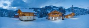 a group of houses on a snow covered field at Lehenriedl Chalet in Wagrain