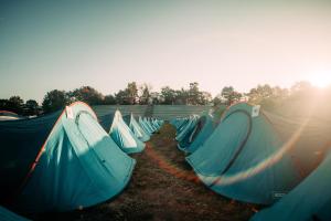a group of tents lined up in a field at ESN Oktoberfest Campsite in Munich