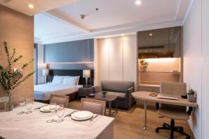 a living room filled with furniture and a table at Jasmine City Hotel - SHA Extra Plus in Bangkok