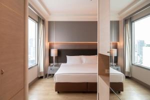 Postel nebo postele na pokoji v ubytování Jasmine City Hotel