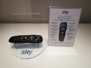a remote control sitting on a table next to a box at Hotel Country House La Radice in Civitanova Marche