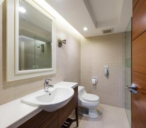 a bathroom with a sink and a toilet at Jasmine City Hotel in Bangkok