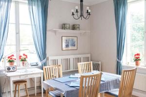 a dining room with a blue table and chairs at 58 Turistvägen Järvsö in Järvsö
