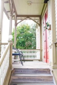 a porch with a bench and a red door at 58 Turistvägen Järvsö in Järvsö