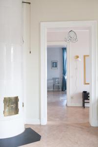 a room with white walls and a hallway with a chandelier at 58 Turistvägen Järvsö in Järvsö