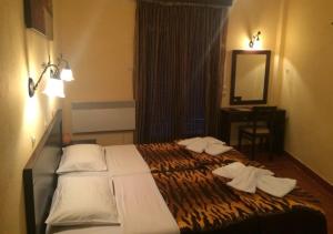 Ένα ή περισσότερα κρεβάτια σε δωμάτιο στο Green Hotel