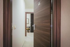 a wooden door in a room with a hallway at Hotel Costa Azul in Balestrate