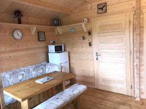 a dining room with a table and a refrigerator at Northwick Farm Lodges in Broadway