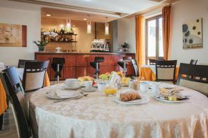 a table with a white table cloth with food on it at Hotel Costa Azul in Balestrate