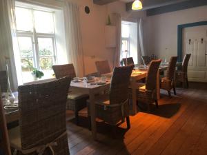a dining room with a long table and chairs at Altes Pastorat Langenhorn in Langenhorn