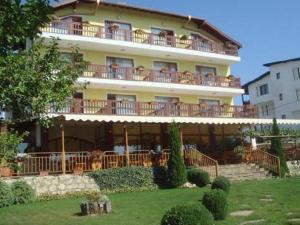 a large yellow building with balconies on top of it at Margarita Hotel in Varna City