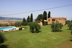 a large yard with a house and a swimming pool at Agriturismo Villa Opera in Volterra