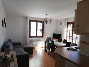 a kitchen and living room with a couch and a table at Edelweiss in Bielsa