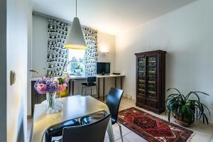 a dining room with a table and chairs and a cabinet at Domizil Familiär in Graz