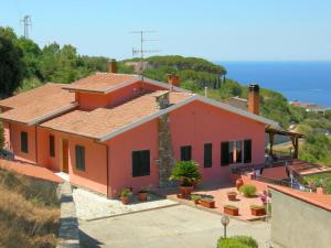 a house on a hill with plants in front of it at Struttura Turistica Villa Calamita in Capoliveri