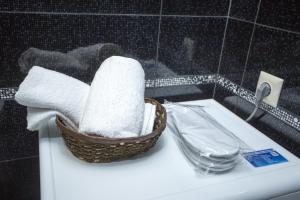 a basket of towels sitting on top of a sink at Luxury Room in Batumi +51 photos