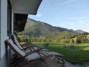 two chairs on a porch with a view of mountains at Alpenchalet in Steinberg am Rofan