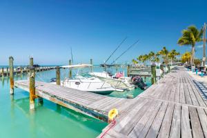 a boat docked next to a dock with a boat at Fiesta Key RV Resort Standard Room 8 in Layton