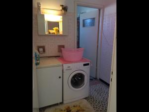 a washing machine in a bathroom with a sink at Pangiotas Pencione in Karpathos