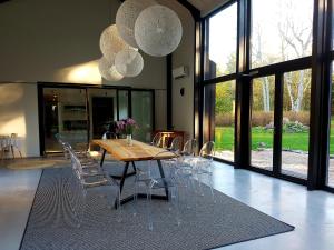 a dining room with a wooden table and chairs at Hõbekala Guesthouse in Kalana