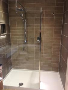 a shower with a glass door in a bathroom at The Beach in Bude