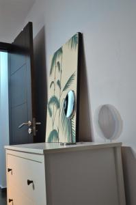 a dresser with a clock on top of it at Apartamento Sauco in Los Llanos de Aridane
