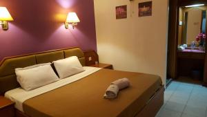 Postel nebo postele na pokoji v ubytování New Orchid Hotel Tuaran