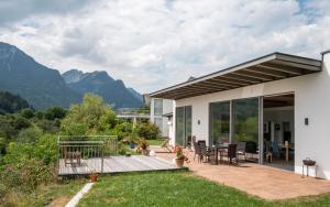 a house with a deck with a view of mountains at Ferienappartement Vastu in Pflach