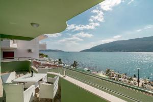 a balcony with a view of a body of water at Apartmani Amor in Herceg-Novi