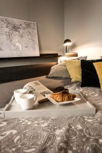 a tray with a plate of food on a bed at Katowice City Centre Apartment in Katowice