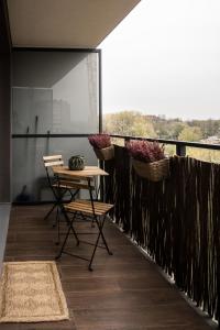 a room with a table and chairs on a balcony at Katowice City Centre Apartment in Katowice