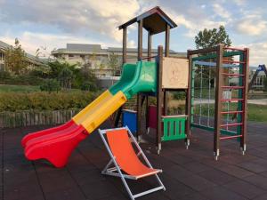 a playground with a slide and a playset at Velence Wellness Apartman in Velence