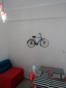 a bike hanging on a wall in a living room at Central Cozy Flat in Athens