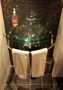 a bathroom sink with a towel hanging on the wall at Borgs Villahotell och B&B in Norrköping